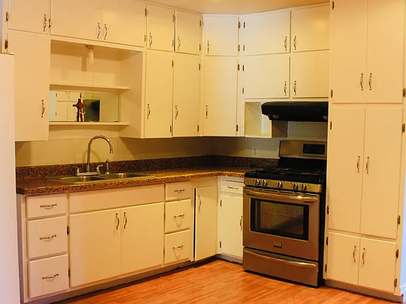 Lovely 4 bd 2 ba House sits on a double lot with a huge backyard and side entrance gate.